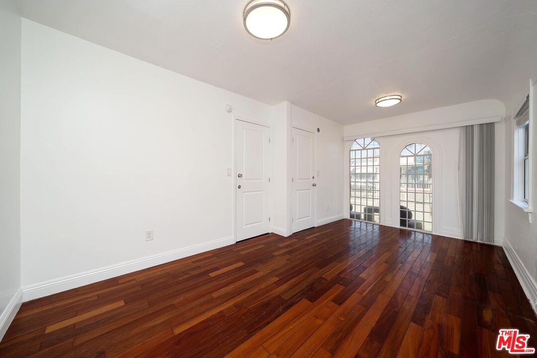 3714 West Pico Boulevard Los Angeles, CA 90019 - Photo 12 of 45 an empty room with wooden floor and windows