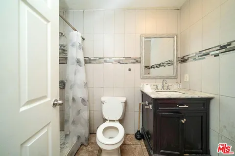 a bathroom with a toilet a sink and a shower