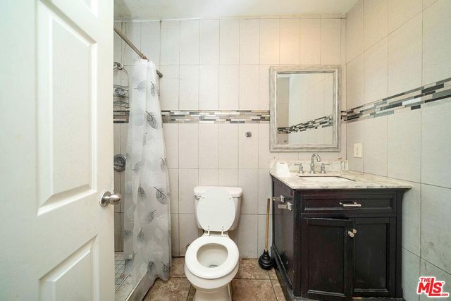 a bathroom with a toilet a sink and a shower