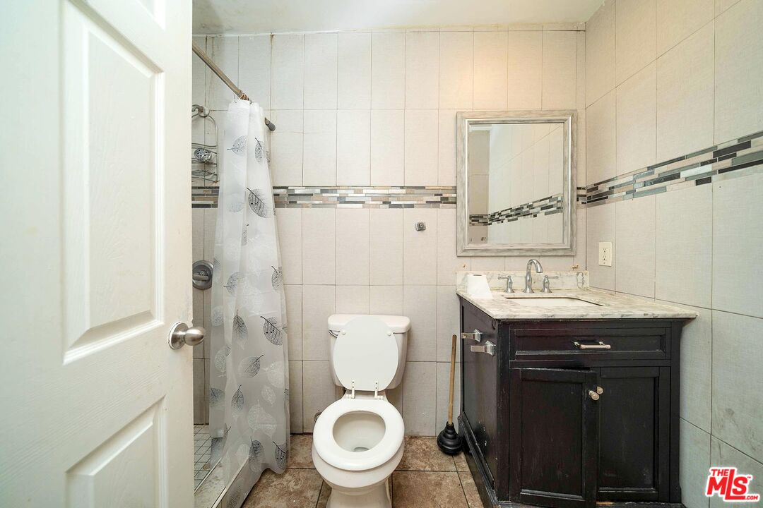3714 West Pico Boulevard Los Angeles, CA 90019 - Photo 19 of 45 a bathroom with a toilet a sink and a shower