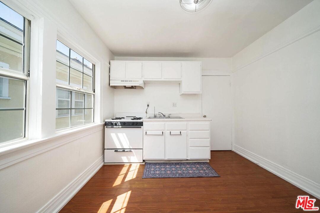 3714 West Pico Boulevard Los Angeles, CA 90019 - Photo 27 of 45 a kitchen with a stove oven and white cabinets