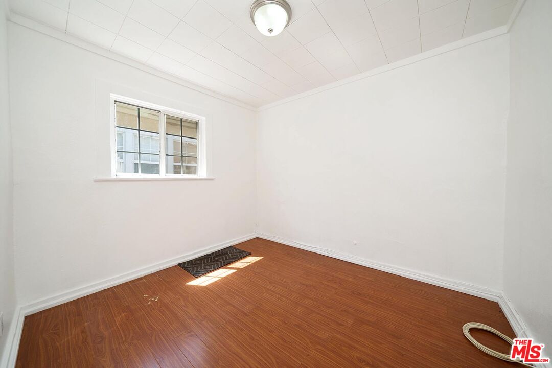 3714 West Pico Boulevard Los Angeles, CA 90019 - Photo 30 of 45 an empty room with wooden floor and windows
