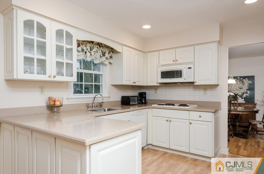 14 Fairfield Road Princeton, NJ 08540 - Photo 9 of 24 a kitchen with stainless steel appliances a sink a stove a microwave a refrigerator and cabinets