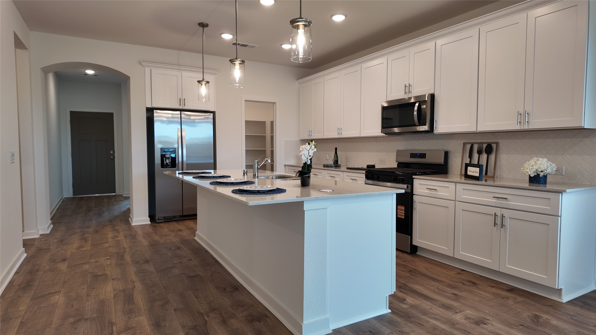 15645 Wandering Maple Way Conroe, TX 77302 - Photo 7 of 14 a kitchen with kitchen island granite countertop a sink a counter top space stainless steel appliances and cabinets