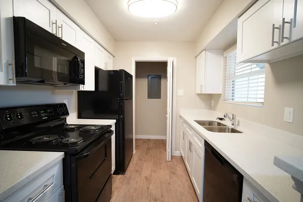 a kitchen with stainless steel appliances a sink stove and refrigerator