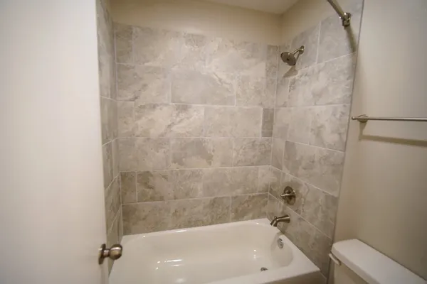 a bath tub sitting next to a white sink