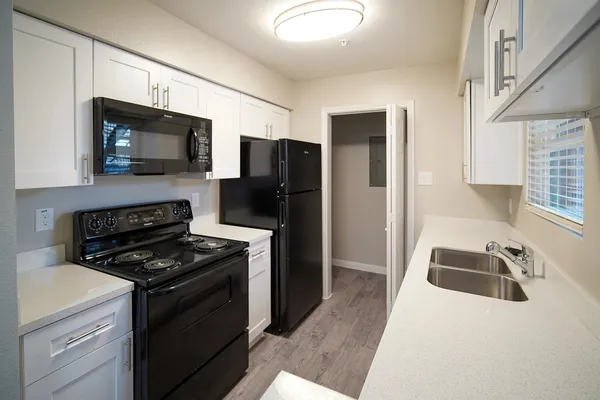a kitchen with a sink stove and refrigerator