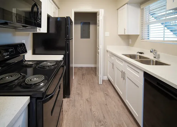 a kitchen with a stove and a refrigerator