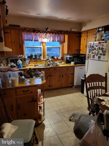 a kitchen with a sink a stove and a refrigerator