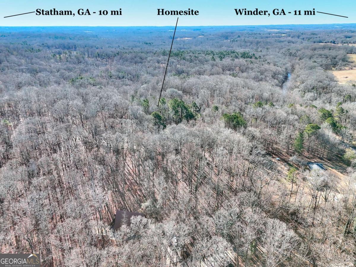 1268 Johnson Mill Road Jefferson, GA 30549 - Photo 2 of 28 a view of a dry yard with wooden fence