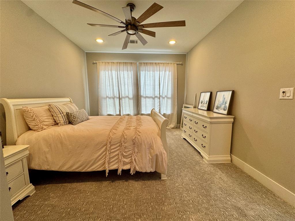 474 Eagle Cove Circle Tioga, TX 76271 - Photo 17 of 25 a spacious bedroom with a bed a dresser and a window