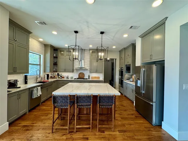 a large kitchen with a table and chairs