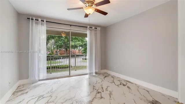 a view of a livingroom with a ceiling fan and a window