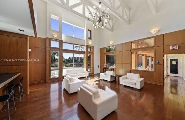 a living room with furniture or chandelier and a wooden floor