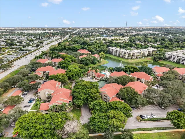 an aerial view of lake and residential houses with outdoor space