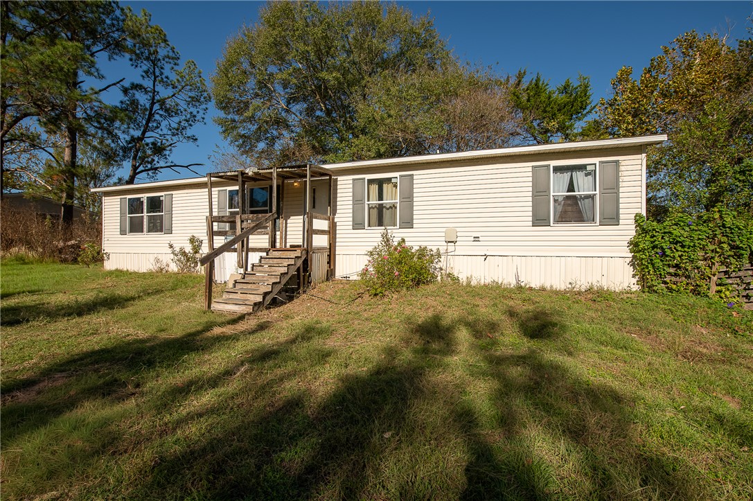 a view of house with backyard