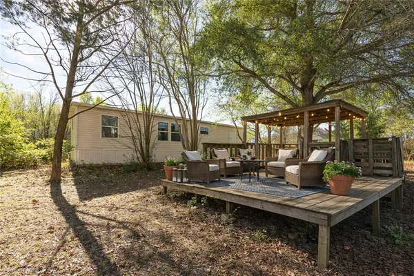 a backyard of a house with barbeque oven table and chairs