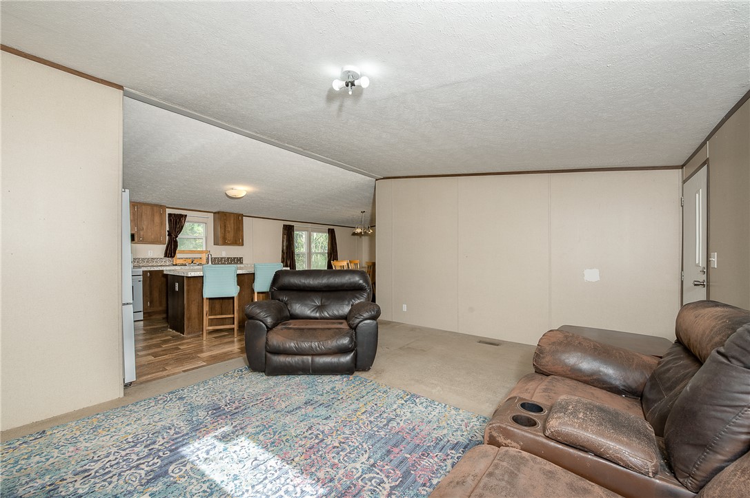 604 Sanders Rd. Lane Franklin, TX 77856 - Photo 17 of 49 Living area featuring a textured ceiling and light colored carpet
