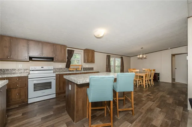 a kitchen with stainless steel appliances granite countertop a sink stove and cabinets