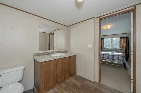 a bedroom with furniture and a large window