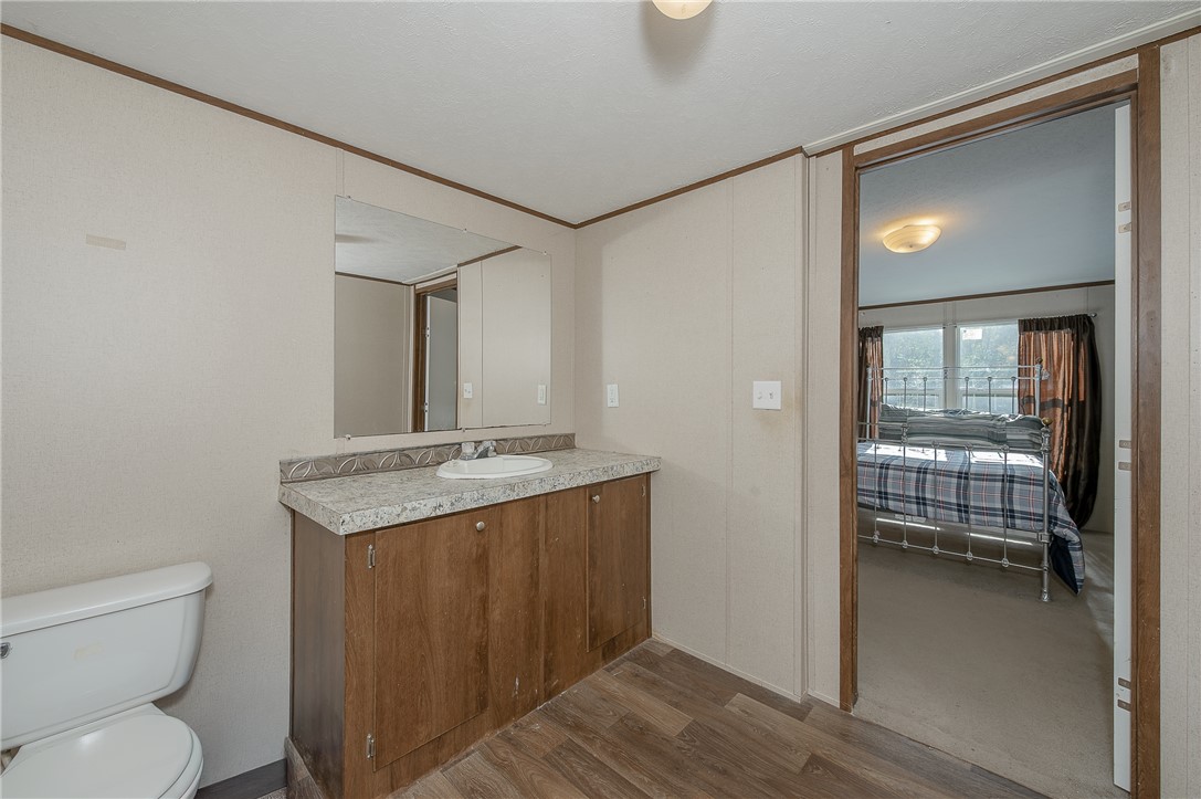 604 Sanders Rd. Lane Franklin, TX 77856 - Photo 21 of 42 a bathroom with a granite countertop sink toilet and mirror