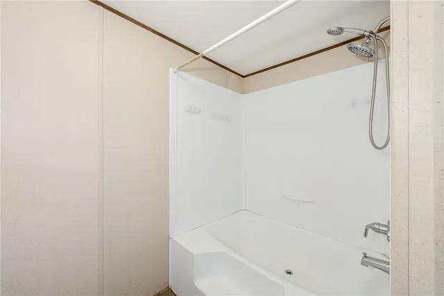 a bedroom with a bed and flat screen tv