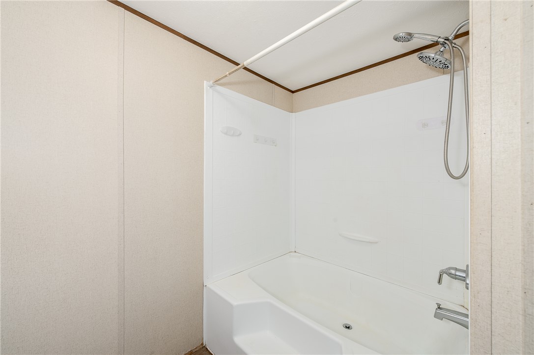 604 Sanders Rd. Lane Franklin, TX 77856 - Photo 23 of 42 a bathroom with a bathtub and a shower