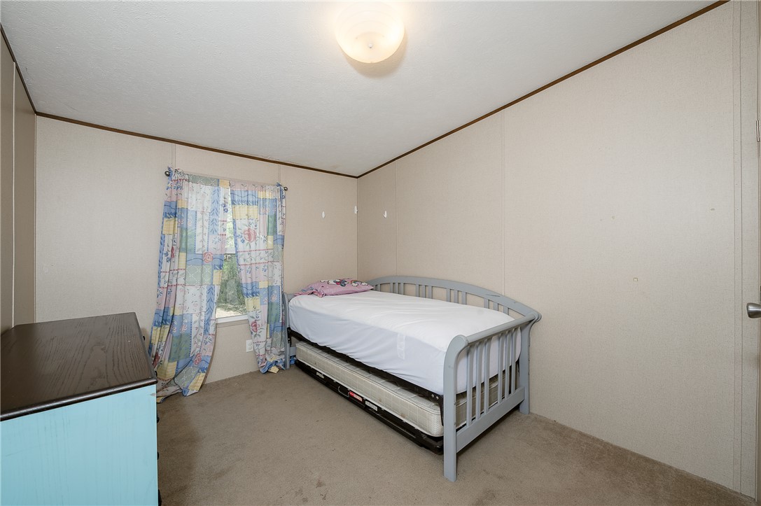 604 Sanders Rd. Lane Franklin, TX 77856 - Photo 27 of 42 a bedroom with a bed and a table in it