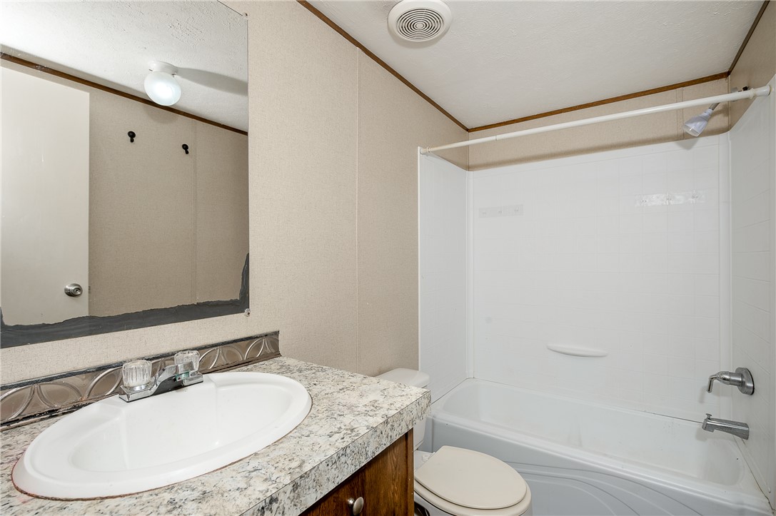 604 Sanders Rd. Lane Franklin, TX 77856 - Photo 29 of 42 a bathroom with a granite countertop sink toilet and a mirror