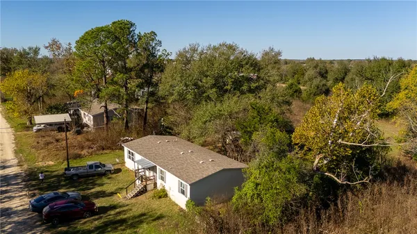 an aerial view of a house with a yard
