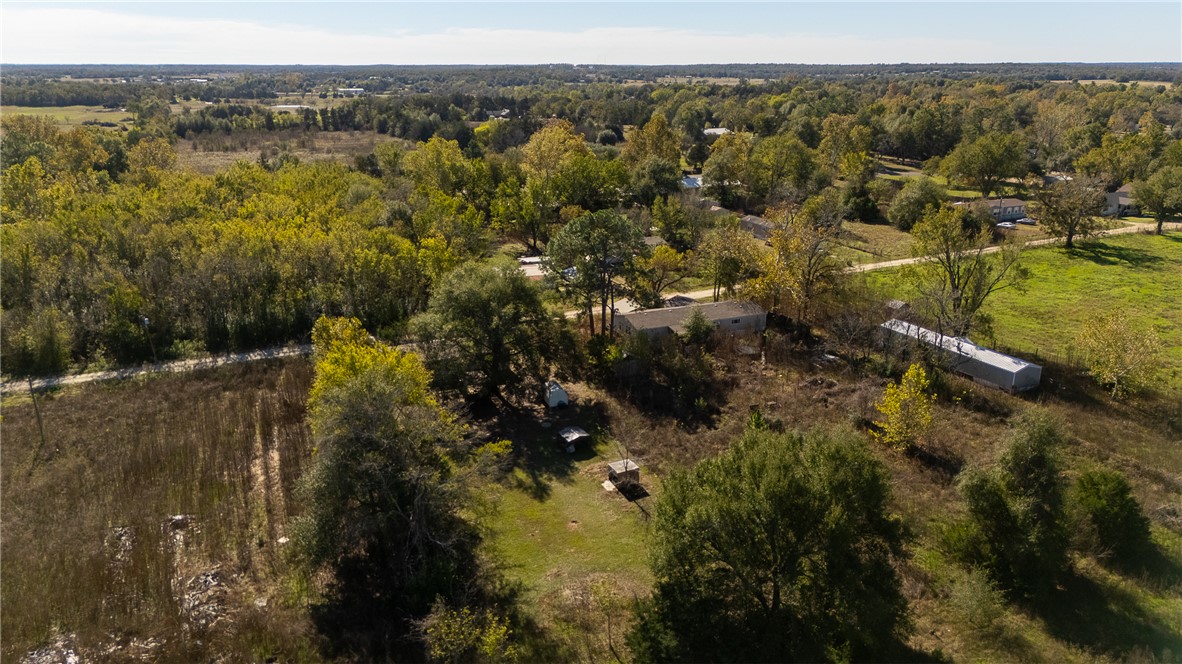 604 Sanders Rd. Lane Franklin, TX 77856 - Photo 45 of 49 Aerial view of property and surrounding area with a heavily wooded area