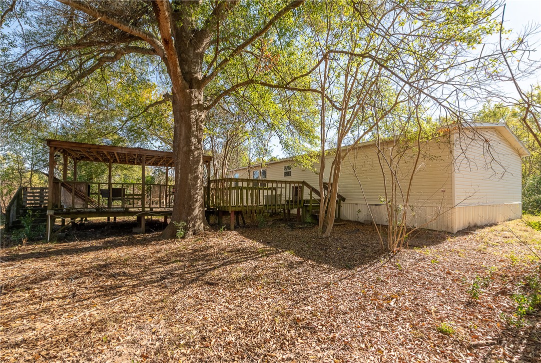 604 Sanders Rd. Lane Franklin, TX 77856 - Photo 5 of 42 a backyard of a house with a tree covered with the trees