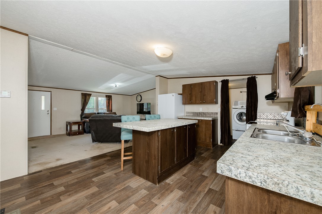 604 Sanders Rd. Lane Franklin, TX 77856 - Photo 47 of 49 Kitchen with a kitchen breakfast bar, open floor plan, light countertops, a kitchen island, and lofted ceiling