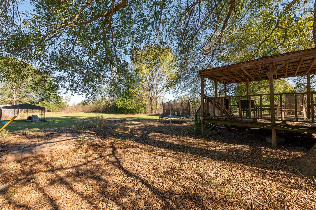 604 Sanders Rd. Lane Franklin, TX 77856 - Photo 9 of 42 a view of a backyard with large trees