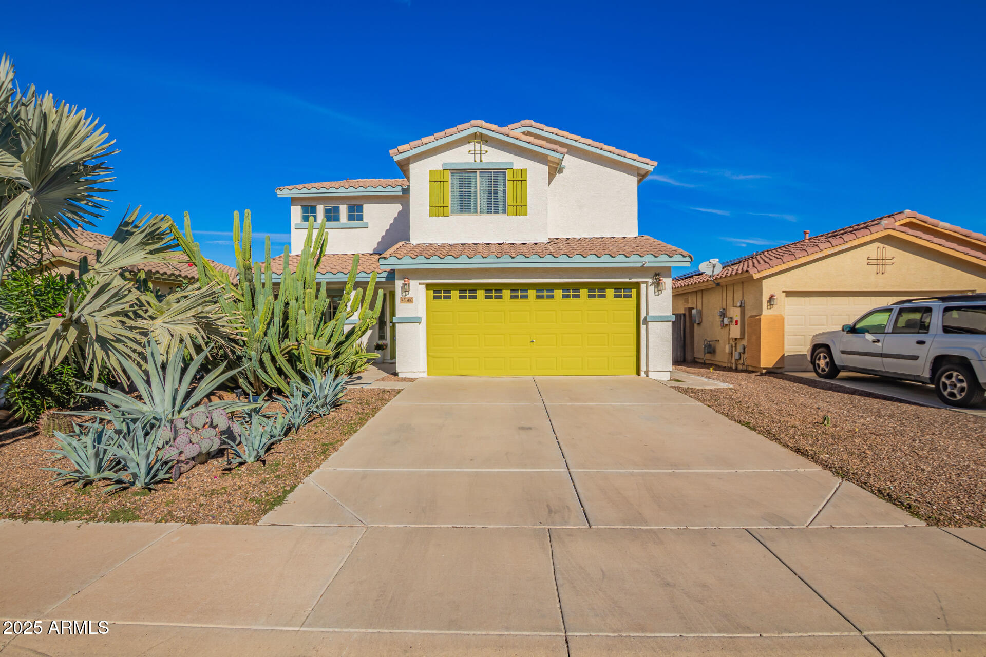 45360 West Desert Garden Road Maricopa, AZ 85139 - Photo 1 of 42 a front view of a house with a yard and garage