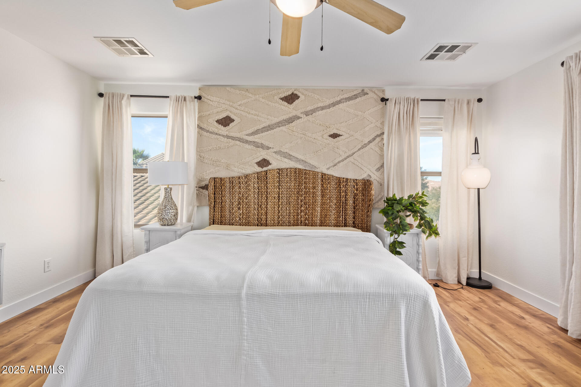 45360 West Desert Garden Road Maricopa, AZ 85139 - Photo 21 of 42 a bedroom with a bed and a chandelier