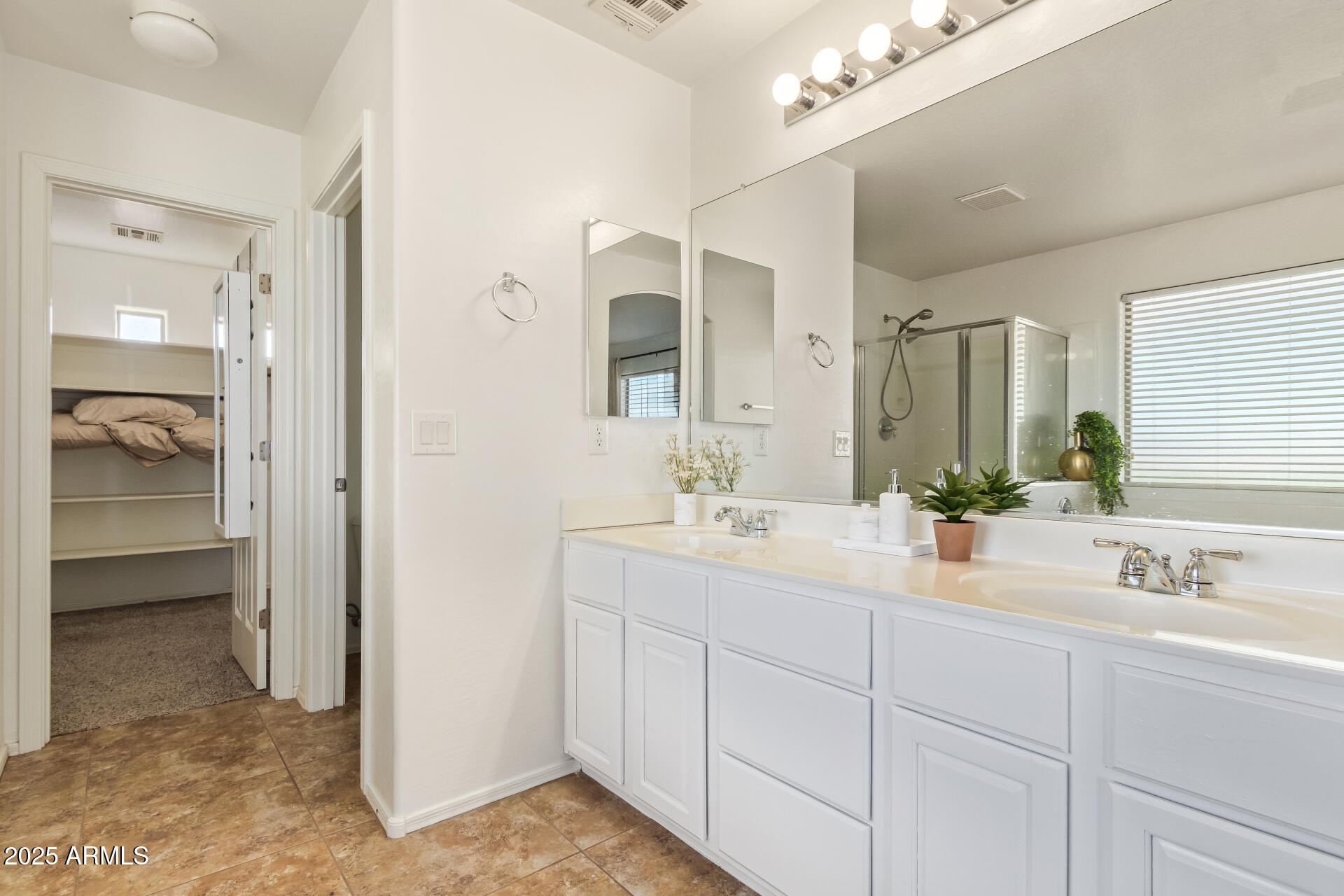 45360 West Desert Garden Road Maricopa, AZ 85139 - Photo 22 of 42 a en suite bathroom with double sink and a mirror