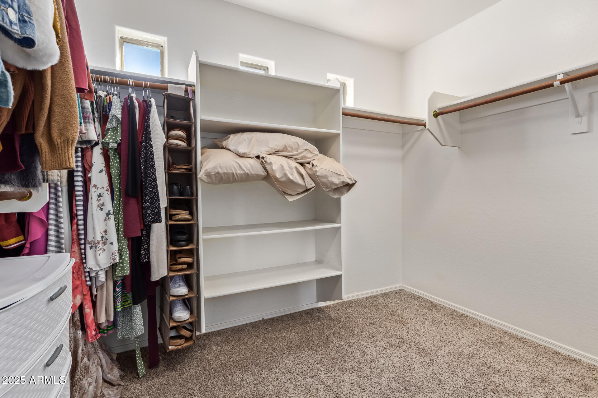 45360 West Desert Garden Road Maricopa, AZ 85139 - Photo 24 of 42 a view of walk in closet with clothes and shoes