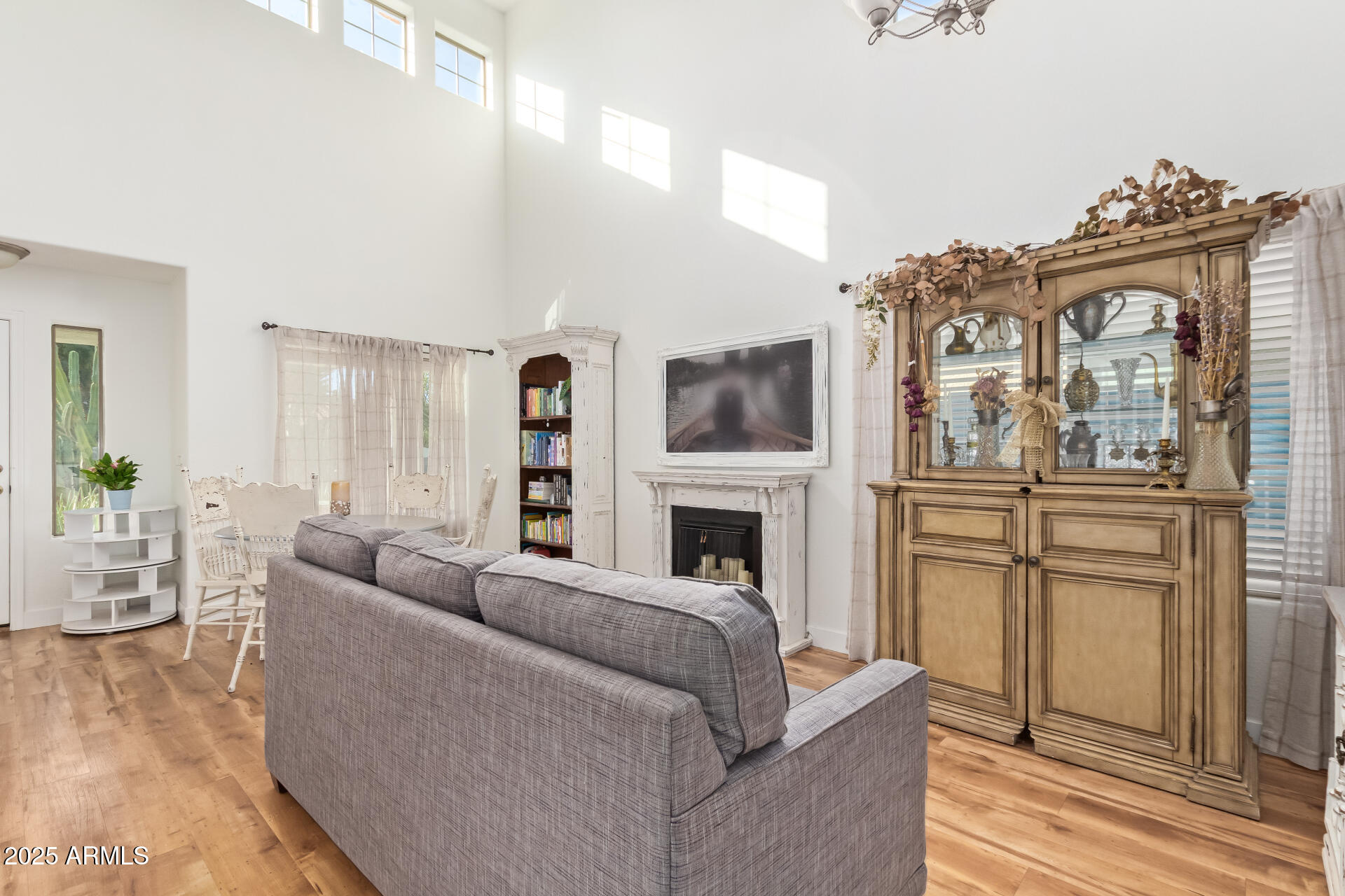 45360 West Desert Garden Road Maricopa, AZ 85139 - Photo 10 of 42 a living room with furniture a fireplace and a flat screen tv