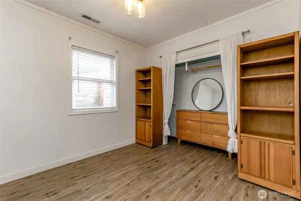 a living room with wooden floor and furniture