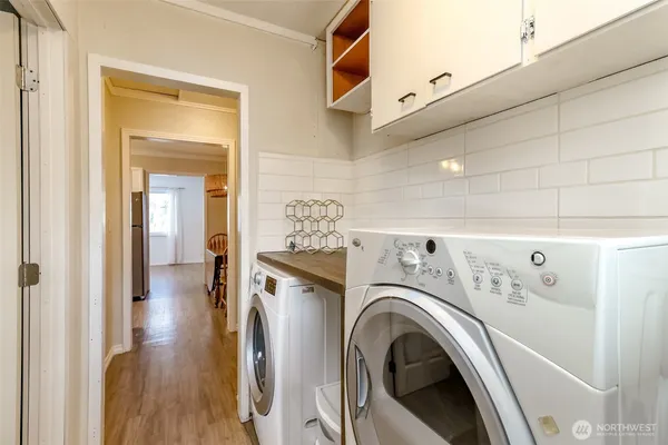 a view of a hallway with washer and dryer