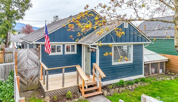 a backyard of a house with a garden and deck