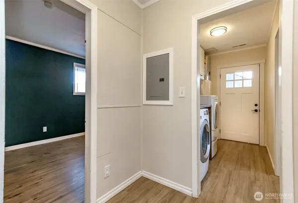 a view of hallway with wooden floor