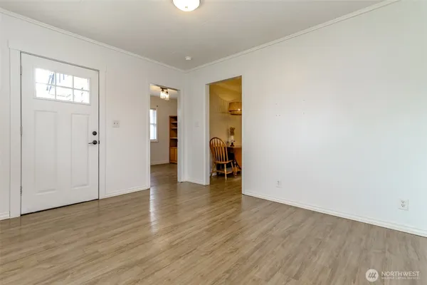 an empty room with wooden floor and closet