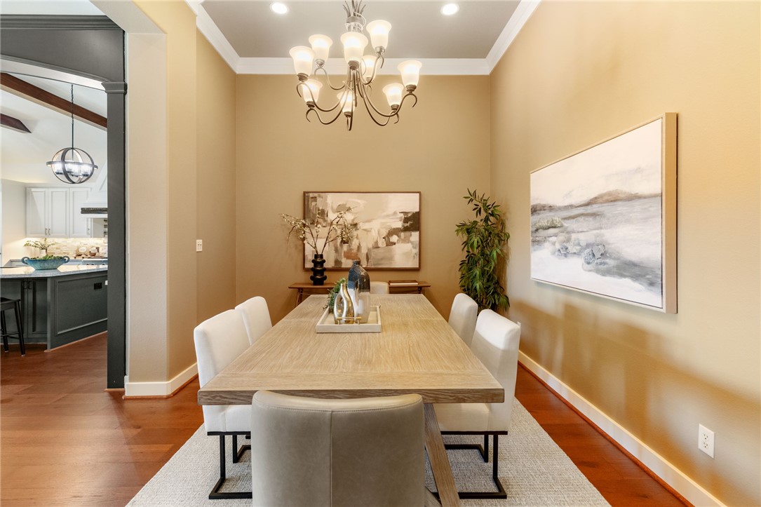 2833 Persimmon Ridge Court Bryan, TX 77807 - Photo 20 of 50 a view of a dining room with furniture a chandelier and wooden floor