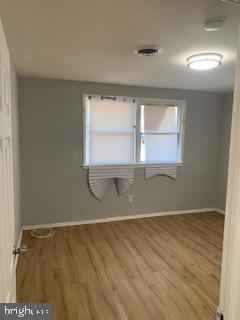 223 Kinsley Road Pemberton, NJ 08068 - Photo 5 of 12 an empty room with wooden floor and windows