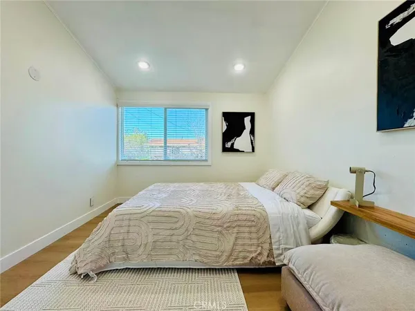 a bedroom with bed and a tv