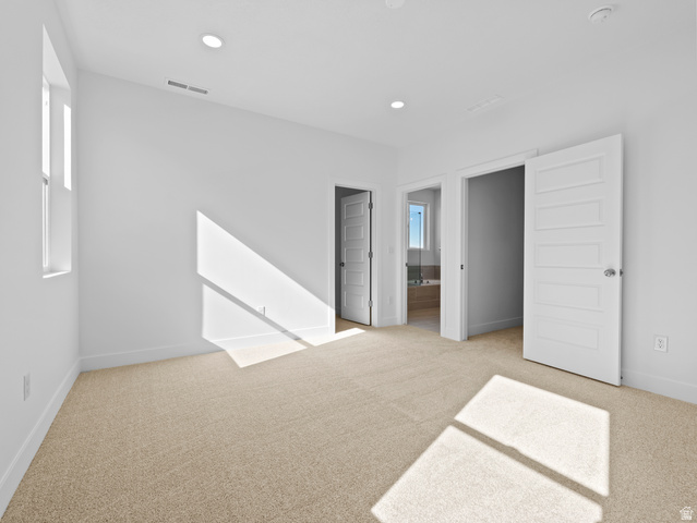 18 South Crimson Way, Unit 304 Mapleton, UT 84664 - Photo 15 of 17 Unfurnished bedroom featuring light carpet, recessed lighting, and ensuite bathroom