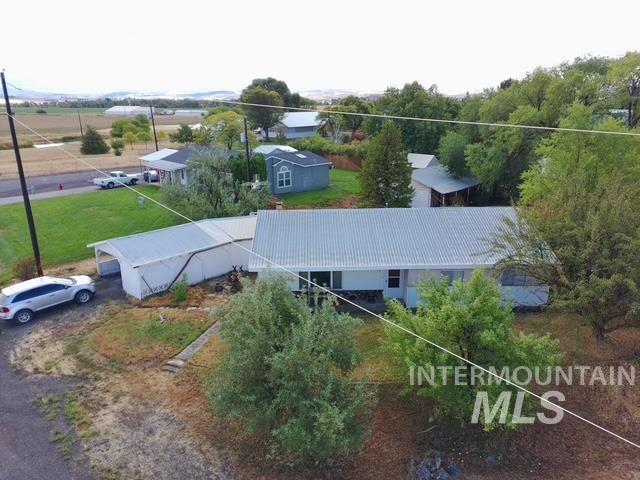 555 Cemetery Road Cambridge, ID 83610 - Photo 41 of 41 Single-story residence featuring a metal roof, attached carport, and surrounding mature trees