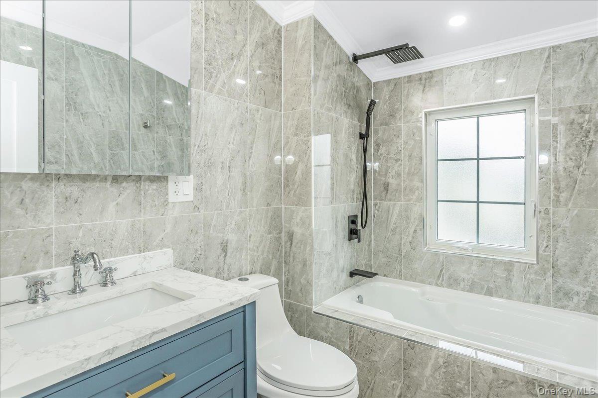 243-36 Caney Road Queens, NY 11422 - Photo 21 of 30 a bathroom with a granite countertop sink toilet tub and shower
